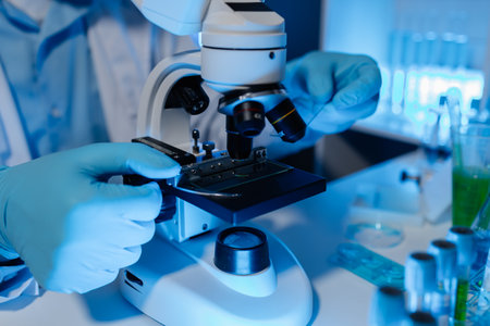 A scientist was using a microscope in a laboratory to examine foreign contaminants when the results came out incorrectly, a chemist conducted research test using microscopeの写真素材