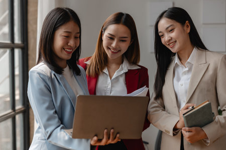 three businessperson are working in the modern office, group of employee has discussion about new project, working as teamwork is more effective, coworkers are brainstorming to planing great strategyの写真素材