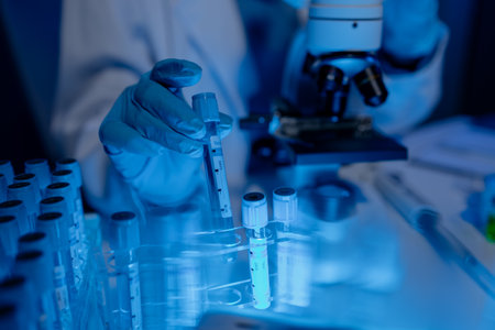 scientist is working on an important liquid inside tube in laboratory, the discovery of a vaccine to protect against currently spreading virus has been discovered, wear gloves and goggles for safetyの写真素材