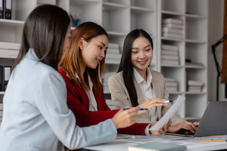 three businessperson are working in the modern office, group of employee has discussion about new project, working as teamwork is more effective, coworkers are brainstorming to planing great strategyの写真素材