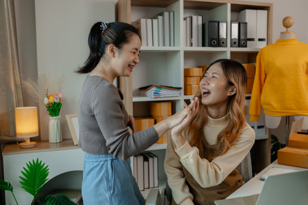 an entrepreneur came to inspect the merchandise in the store where her employees were working on getting the clothing items ready for delivery to customers from the shopの写真素材