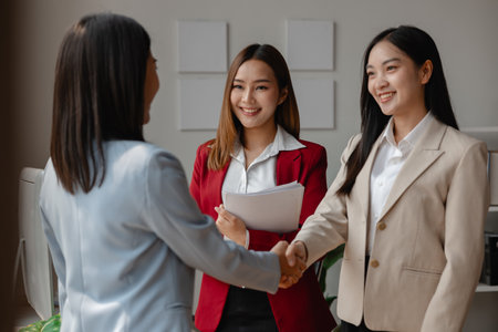 two big companies handshake because they agree on a business deal, businesspeople just signed commitment contract for merge and expand their business for they will get more customer base than normallyの写真素材