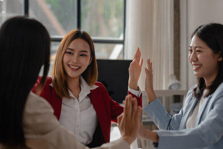 three businesswoman are extremely happy about big achievement from their project that they have been working hard on it because they just got an email said the winner reward is themの写真素材