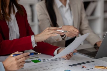 three businessperson are working in the modern office, group of employee has discussion about new project, working as teamwork is more effective, coworkers are brainstorming to planing great strategyの写真素材
