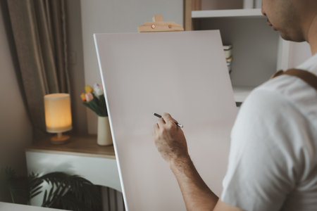 an artist is sitting in his own painting studio with his various painting tools, which is canvas, palette, watercolors, oils, poster colors , artistic, painter, colours, creativity, skillsの写真素材