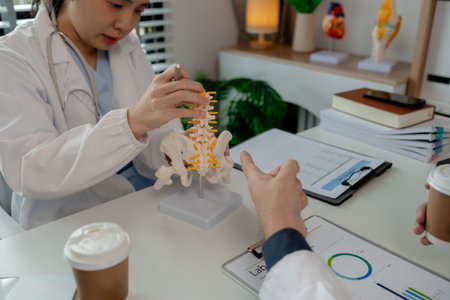 two surgeons are sitting in a private office at a hospital discussing an upcoming major pelvic...