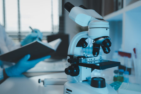 a scientist uses a microscope to look for contaminants in a test sample, a researcher uses a...