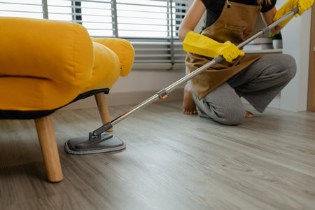 she is mopping floor in living room, as a wife she love to keep the house clean to make sure...