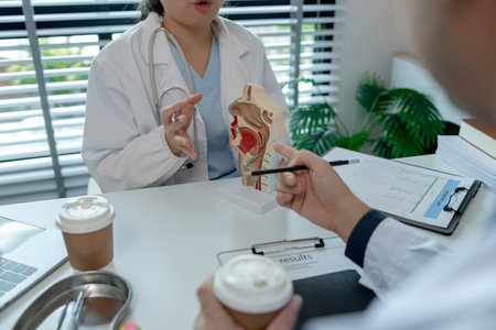 two ENT specialists are discussing the most appropriate treatment for a patient, the two doctors are exchanging their opinions on ENT treatment, anatomy, stethoscope, modelの写真素材