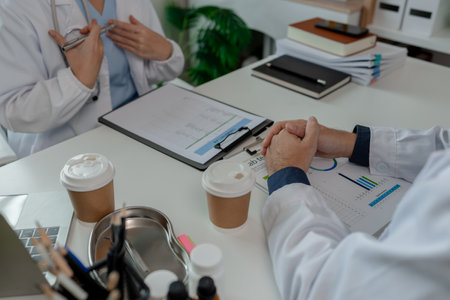 two doctors sat in a private office at the hospital discussing and exchanging knowledge with each other, doctors discussed the way that would be the most appropriate treatment, stethoscope, specialistの写真素材