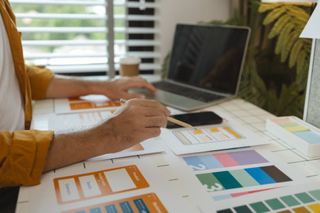 A web designer is using his idea to create a digital product design project that will meet the needs of users in terms of both appearance and feel when using it, ux, ui, interface, experience.の写真素材