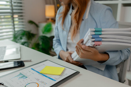a businesswoman is working in her office at workplace, an employee works at the desk about new...
