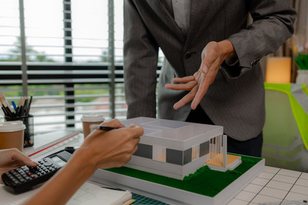 engineer and investor are negotiating the details of a housing project that will soon be built, an...