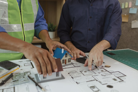two architect is in office and sharing their strategy idea of building plan to each other, there are...