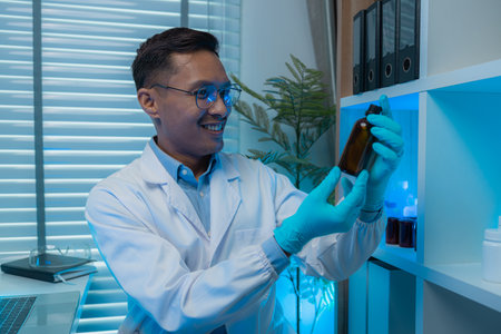 a scientist is happily work in the laboratory, a science researcher is working on his project about...