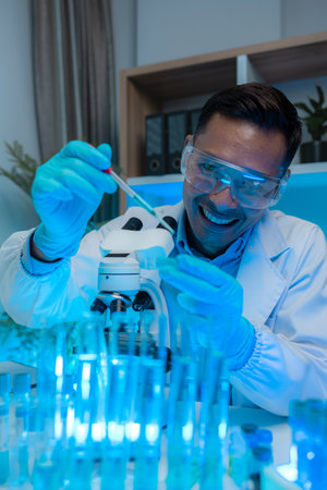 a scientist is happily work in the laboratory, a science researcher is working on his project about...