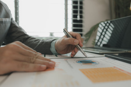 a businessman is in his private office and working with a lot of paperwork, a senior executive of...