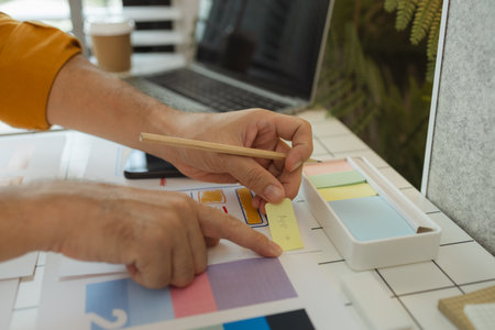 A digital product developer is working on a plan to work with research data to guide the development of a website that is as effective as possible for users, while also being visually appealingの写真素材