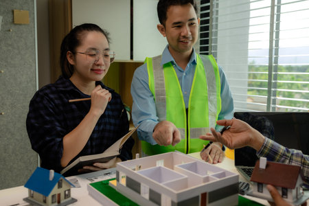 A meeting of architects who work hard together to create outstanding work. Engineers and contractors collaborate to solve problems that arise in design and construction.の写真素材