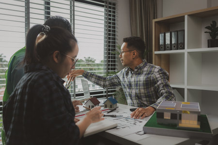 A meeting of architects who work hard together to create outstanding work. Engineers and contractors collaborate to solve problems that arise in design and construction.の写真素材