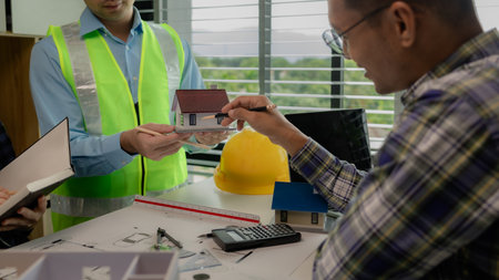 A meeting of architects who work hard together to create outstanding work. Engineers and contractors collaborate to solve problems that arise in design and construction.の写真素材