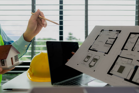 A meeting of architects who work hard together to create outstanding work. Engineers and contractors collaborate to solve problems that arise in design and construction.の写真素材