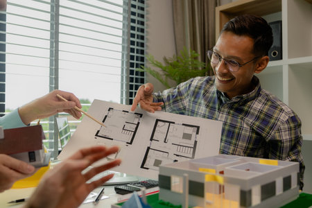 Engineers and contractors collaborate to solve problems that arise in design and construction, architects meets in the office to analyze the design structure to ensure it meets the client's wants.の写真素材