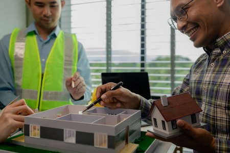 A meeting of architects who work hard together to create outstanding work. Engineers and contractors collaborate to solve problems that arise in design and construction.の写真素材