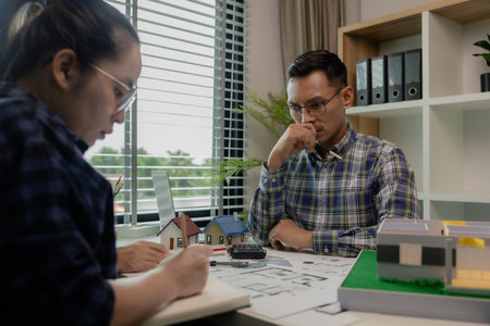 A meeting of architects who work hard together to create outstanding work. Engineers and contractors collaborate to solve problems that arise in design and construction.の写真素材