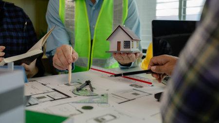 A meeting of architects who work hard together to create outstanding work. Engineers and contractors collaborate to solve problems that arise in design and construction.の写真素材