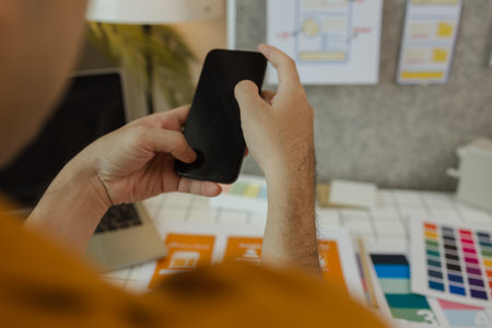 A web developer, as a User Experience and User Interface Officer is analyzing data from his ideas to develop the structure and components of a digital product, ux, ui, interface, experienceの写真素材