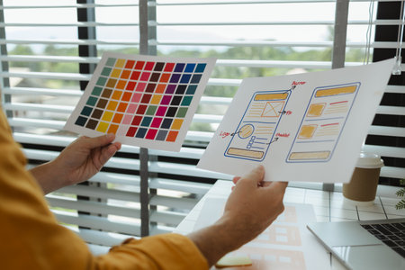 A web developer is analyzing data from his ideas to develop the structure and components of a digital product that best meets the needs of users, ux, ui, interface, experienceの写真素材