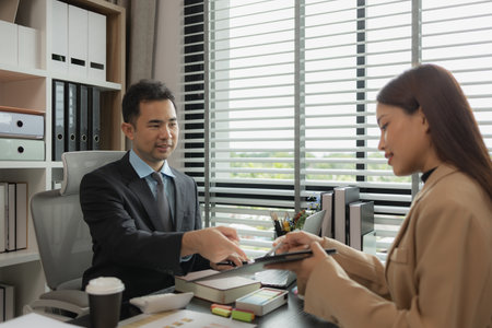 they are working on the new project together in the office, a lot of paperwork on the desk that this group of businessman have to working on, business meeting, workplace, businesspeopleの写真素材