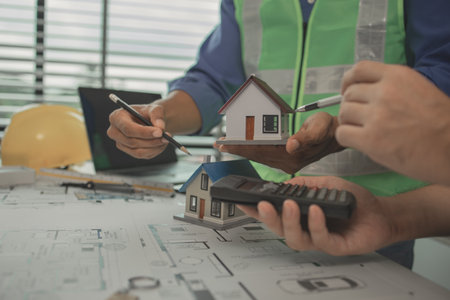 two architect is in office and sharing their strategy idea of building plan to each other, there are...
