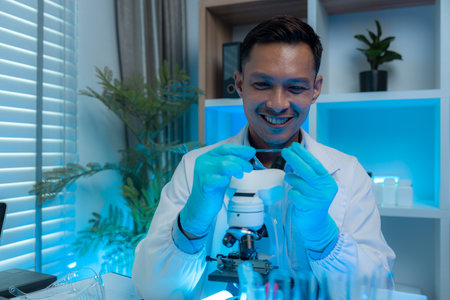 a scientist is happily work in the laboratory, a science researcher is working on his project about...