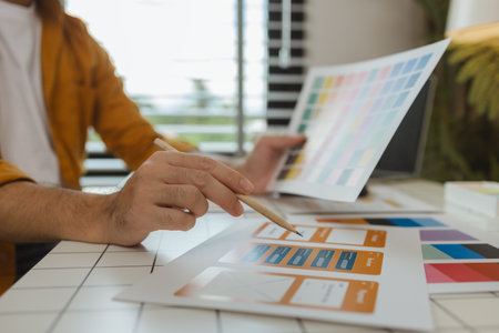 A web designer is using his idea to create a digital product design project that will meet the needs of users in terms of both appearance and feel when using it, ux, ui, interface, experience.の写真素材