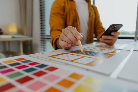 A web developer, as a User Experience and User Interface Officer, is designing beautiful and easy-to-use digital products that create a positive emotional and visual experience for users.の写真素材