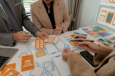The web design team is consulting to exchange ideas on how to develop digital products that are modern and user-friendly, suitable for today's users, ux ui teamの写真素材