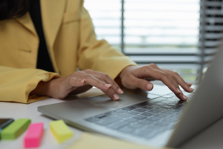 a female executive office working is sitting and working in her private office, a female company owner sits in her company's office, entrepreneur, businesswoman works with a lot of paperworkの写真素材