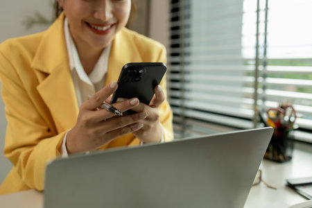 A beautiful businesswoman is working in her private office. A female employee is working in a company office. The professional working of a businesswoman in the present day.の写真素材
