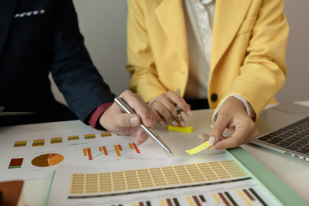 Businessman brainstorming to find strategies to increase revenue for the company. Two coworkers are discussing about the work in progress. Two employees are working as a team. Business meeting.の写真素材