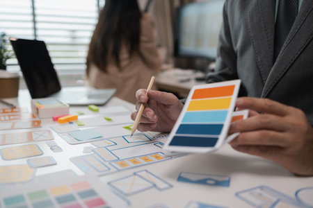 drawing website ux ui app for mobile phone application and development template layout, UI development, designer team working on a project of ux ui in creative office, team of creative webの写真素材