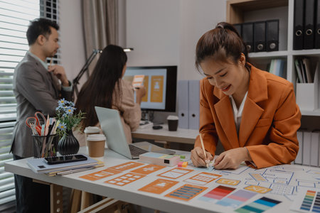 drawing website ux ui app for mobile phone application and development template layout, UI development, designer team working on a project of ux ui in creative office, team of creative webの写真素材