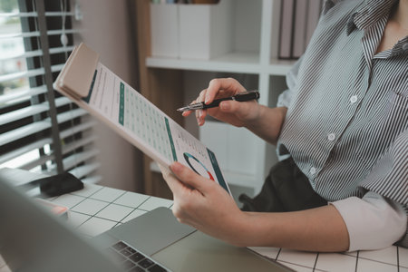 businesswoman working on laptop in her studio, businessperson working on a digital tablet and laptop in an office, busy professional executive leader working on business finances analysisの写真素材