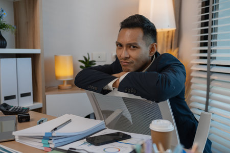 businessman in office relaxing in the office, calm businessman sit relax in his private office workplace take a break, happy relaxed young, man, Asian businessman is relaxing after finishing workの写真素材