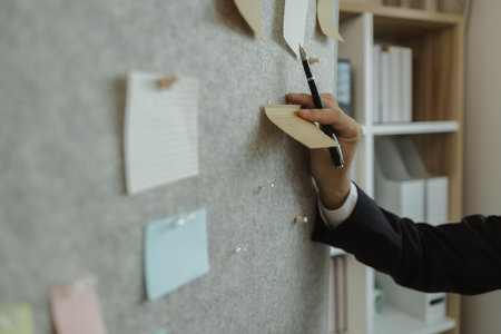 A businessman is planning a strategy to work efficiently and have the most positive impact on the company. An executive of a company is organizing ideas into a concrete form for easy understanding.の写真素材