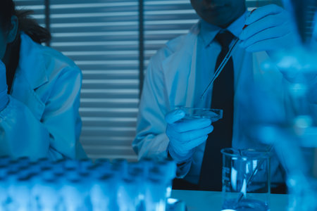 lab, team of medical research scientists work on a new generation disease cure, they use scientific equipment, test tubes, data implementing technology, laboratory looks busy,の写真素材