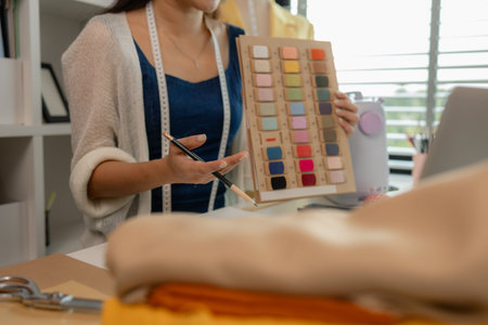 a beautiful seamstress is selling her products online to increase her income and also to communicate directly with customers without having to meet themの写真素材