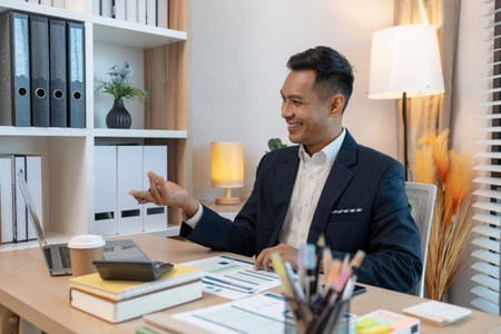 a businessman is talking on the phone with his colleague, a man is working in the office at company of accountant, an employee is in his private officeの写真素材