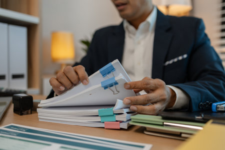 stamped the document to approve, businessman professional working while sitting at office desk, accountant, marketing, employee is working alone in the office, approving report,の写真素材
